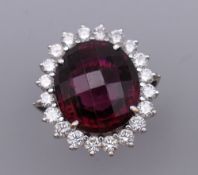 An 18 ct white gold diamond and red stone ring. Ring Size L/M. 18.5 grammes total weight.