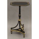 A 19th century black and gilt painted tilt top tripod table. 73 cm high.