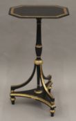 A 19th century black and gilt painted tilt top tripod table. 73 cm high.