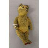 A vintage teddy bear, with tail controlling head movements. 26 cm high.