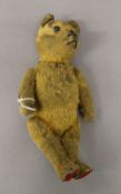 A vintage teddy bear, with tail controlling head movements. 26 cm high.