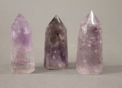 Three mineral obelisks. The largest 10 cm high.