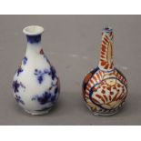 A miniature Japanese Imari vase and another miniature vase. The former 8 cm high.