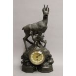 A Blackforest carved wooden mantle clock surmounted with chamois deer. 53 cm high.