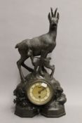 A Blackforest carved wooden mantle clock surmounted with chamois deer. 53 cm high.