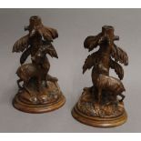 A pair of Blackforest carved wooden stands, each carved with a chamois deer. The largest 23.