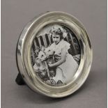 A small silver circular photograph frame. 7 cm diameter.