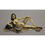 A cold painted bronze model of a girl and tiger. 15 cm wide.