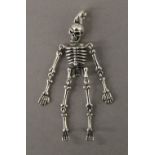 A silver skeleton form pendant. 7 cm high.