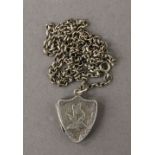 An Edwardian silver double photo locket, on silver chain. The locket 2 cm high. 8.