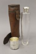 A silver mounted glass spirit flask in leather case. 23 cm high overall.