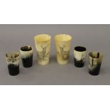 Six vintage horn beakers, two carved with a stag. The largest 11.5 cm high.