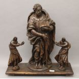 A 17th century carved wooden model of an apostle and two carved wooden angels,