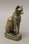 A model of an Egyptian cat and a Cairoware type brass bowl. The former 20 cm high.