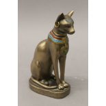 A model of an Egyptian cat and a Cairoware type brass bowl. The former 20 cm high.