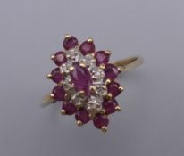 A 9 ct gold multi-stone ruby and diamond ring. Ring Size L. 1.9 grammes total weight.