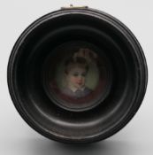 A 19th century French miniature enamel portrait, framed and glazed. 6.75 cm diameter overall.