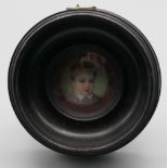 A 19th century French miniature enamel portrait, framed and glazed. 6.75 cm diameter overall.