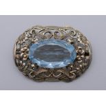An 835 silver brooch centred with a blue stone, possibly aquamarine.