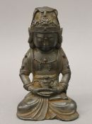A Chinese bronze Buddha with dark patination. 18.5 cm high.