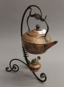 An Arts & Crafts wrought iron and copper kettle on stand. 38 cm high.