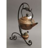 An Arts & Crafts wrought iron and copper kettle on stand. 38 cm high.