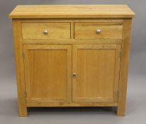 A modern oak side cupboard. 96 cm wide.