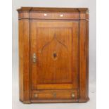 A George III inlaid oak hanging corner cupboard. 104.5 cm high.