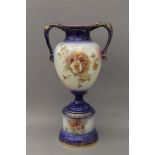 A Victorian porcelain twin handled vase on stand. 59 cm high.