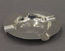 A silver ashtray. 10 cm diameter.