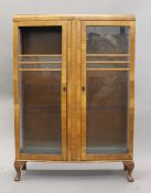 An early 20th century walnut display cabinet. 87 cm wide.