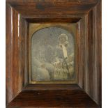 A Victorian framed photograph on glass plate of a couple. 13 x 14.5 cm overall.
