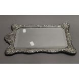 A silver framed mirror. 38 cm high.