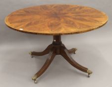 A circular cross banded mahogany centre table. 131 cm diameter.