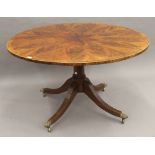 A circular cross banded mahogany centre table. 131 cm diameter.