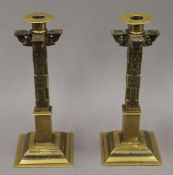 A pair of 19th century brass hand tooled Sri Lankan temple candlesticks. 25 cm high.