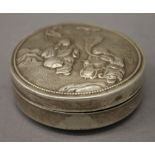 A Chinese silver circular box. 8 cm diameter.