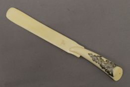 A 19th century ivory page turner with silver pierced work to handle. 31.5 cm long.