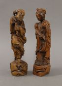 A pair of Chinese wooden figures. The largest 30 cm high.