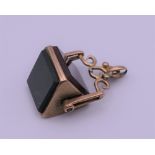 A 9 ct gold triangular swivel fob. 2.5 cm high. 7.1 grammes.