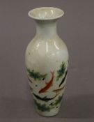 A small Chinese porcelain vase decorated with fish. 16.5 cm high.