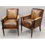 A pair of Bergere armchairs, with leather padded arms leather covered removable cushions.