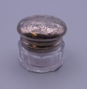 A small unmarked white metal mounted glass vinaigrette,