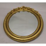 A Victorian gilt framed oval mirror. 100 cm high.