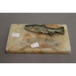 An alabaster ashtray mounted with a model of a fish. 19 cm wide.
