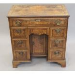 An 18th century style walnut knee hole desk. 75 cm wide.