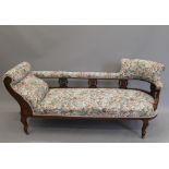 A Victorian walnut framed chaise lounge and an open armchair en suite. The former 185 cm long.