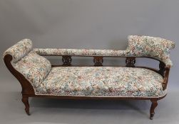 A Victorian walnut framed chaise lounge and an open armchair en suite. The former 185 cm long.