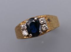 An unmarked gold diamond and sapphire ring. Ring size N/O. 5.5 grammes total weight.