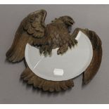 A 19th century Blackforest mirror formed as an eagle. 25 cm wide.